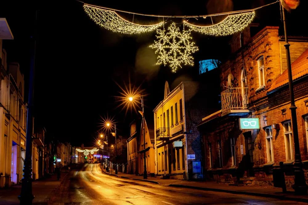 Illuminated LED snowflake pole motif mounted on a street light